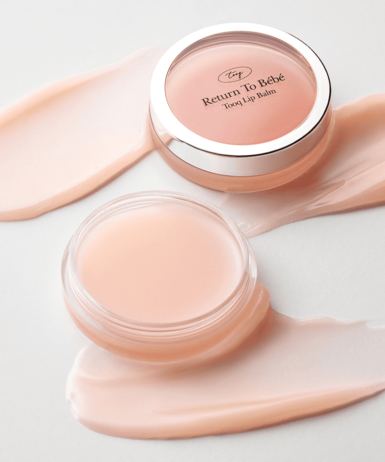 TOOQ Return To BÃ¨bÃ¨ Lip Balm in open containers with smooth creamy texture.