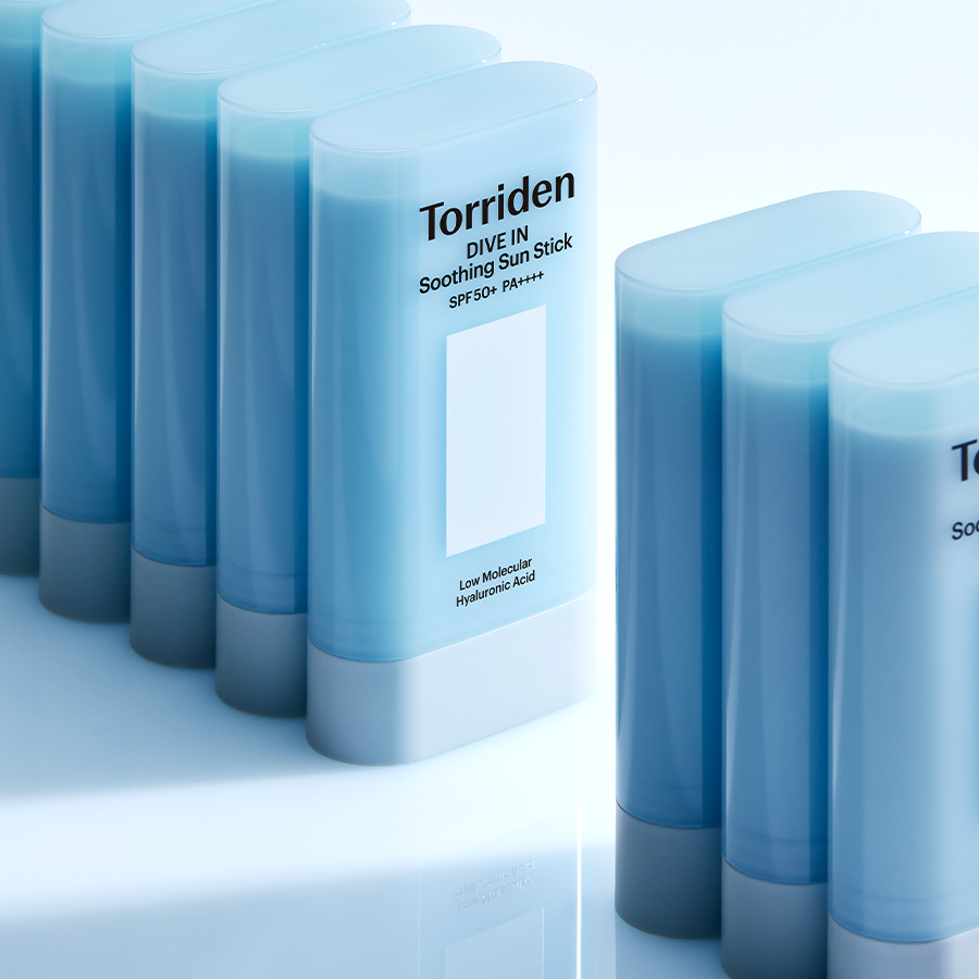 TORRIDEN Dive In Soothing Sun Stick SPF50+PA++++ 19g in multiple blue containers on a reflective surface.