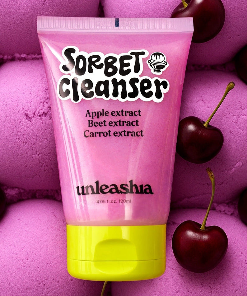 UNLEASHIA ABC Sorbat Facial Cleanser 120ml with apple, beet, and carrot extracts surrounded by cherries on pink background.