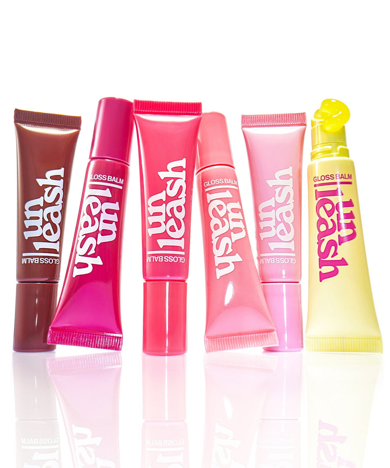 Assorted tubes of UNLEASHIA Sunset Dazzle Gloss Balm in vibrant colors.