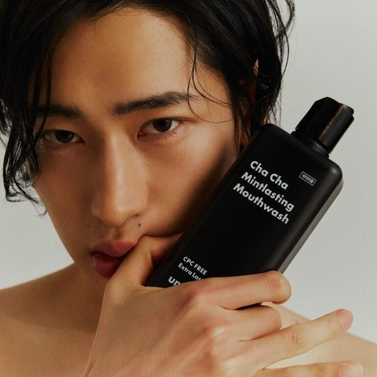 Model holding UNPA Cha Cha Mintlasting Mouthwash 300ml bottle, showcasing product's sleek design and branding.