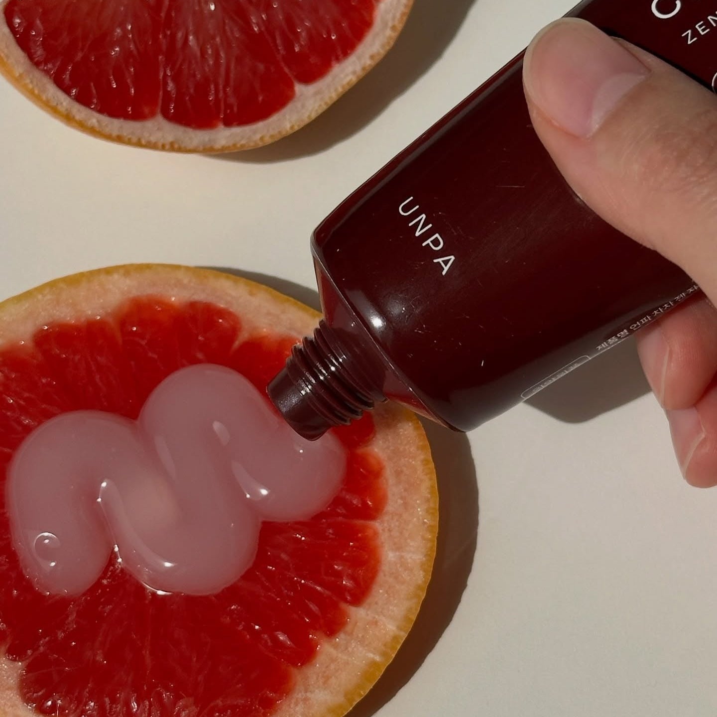 UNPA Cha Cha Zen Grapfruit Scent 1450 High Fluoride Toothpaste 100g on sliced grapefruit