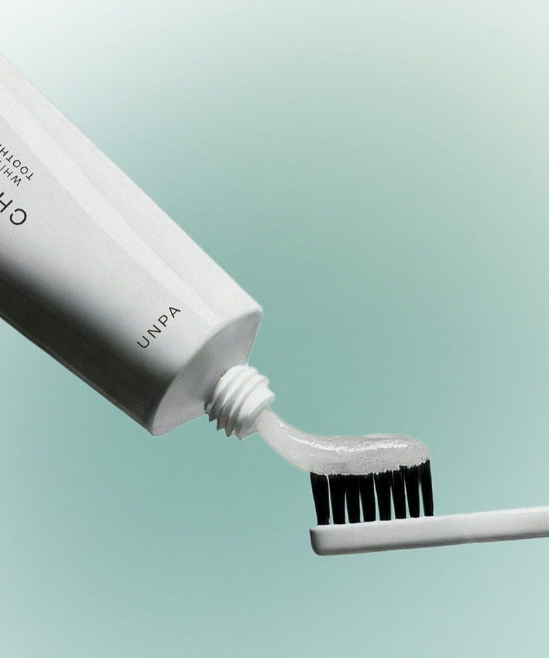 UNPA Chacha French Chamomile Vegan Whitening Toothpaste 90g being applied to toothbrush