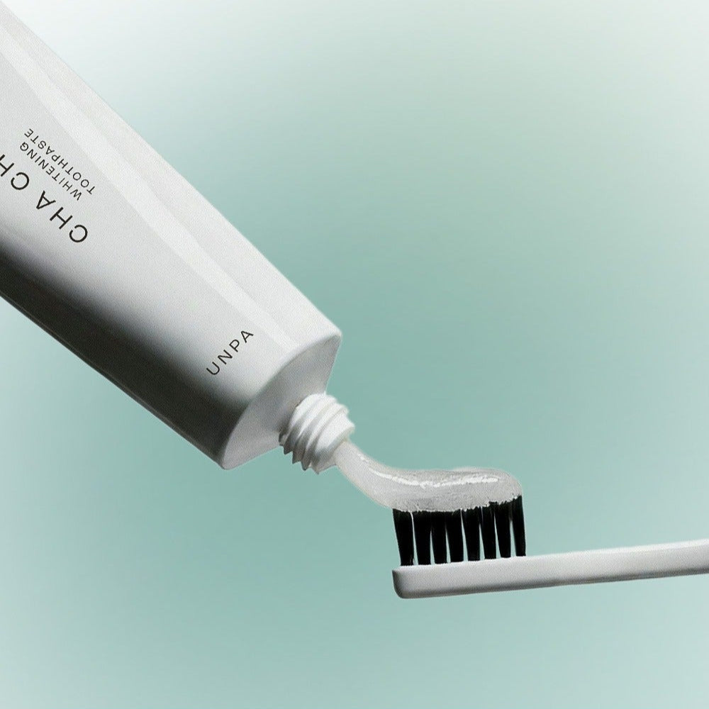 UNPA Chacha French Chamomile Vegan Whitening Toothpaste 90g being applied to toothbrush