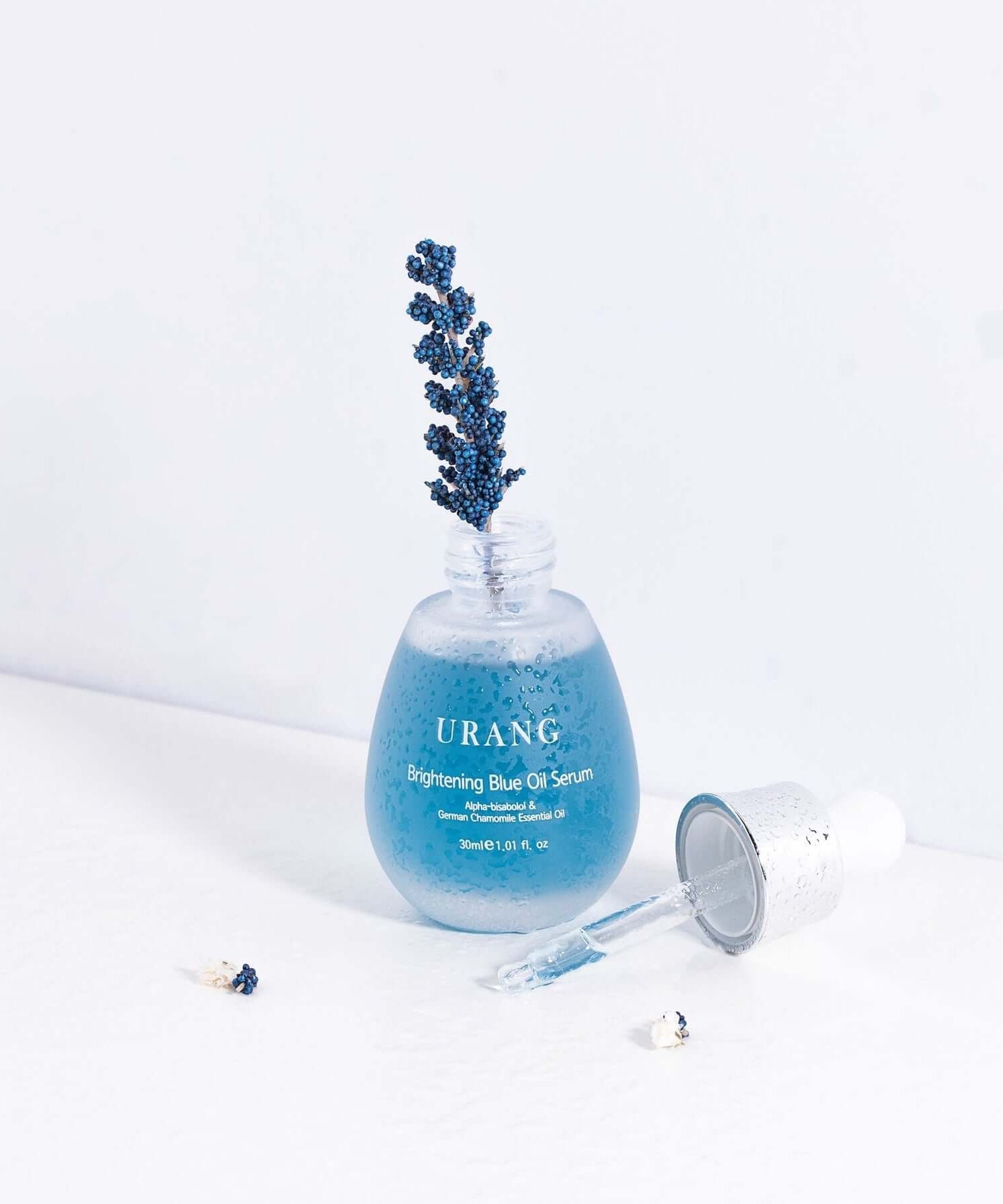 URANG Brightening Blue Oil Serum 30ml bottle with dropper on a white background featuring a lavender sprig.
