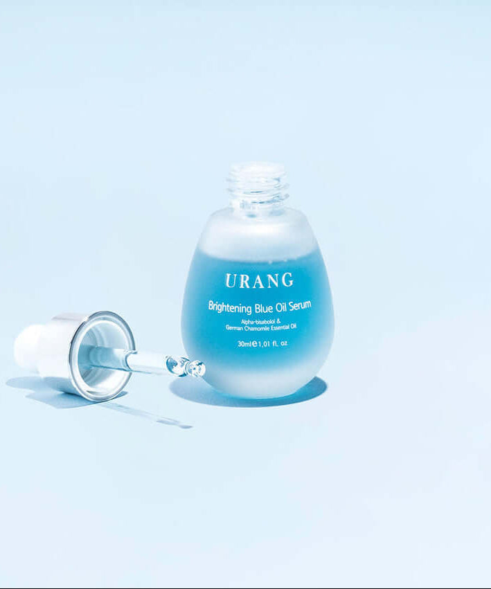 URANG Brightening Blue Oil Serum 30ml bottle with dropper on light blue background.