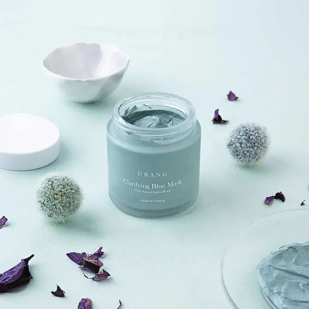 URANG Clarifying Blue Mask jar surrounded by decorative elements on a light background.
