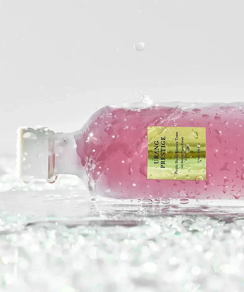 URANG Prestige Purple Shield Essence Toner bottle on wet surface with water droplets
