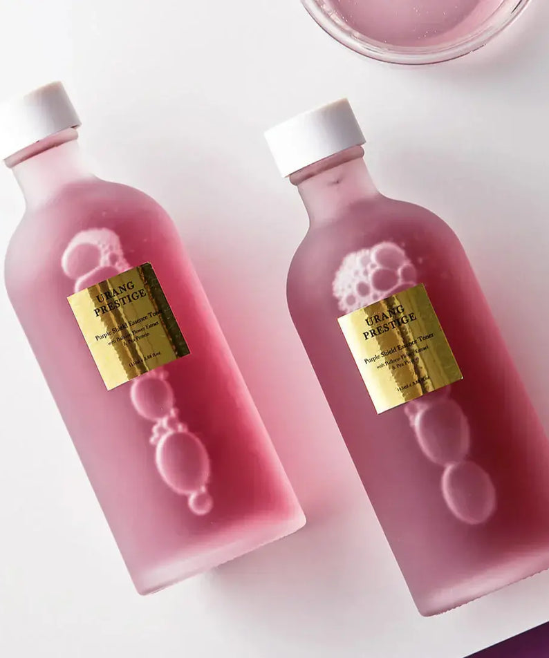 URANG Prestige Purple Shield Essence Toner bottles with golden labels on a white background.