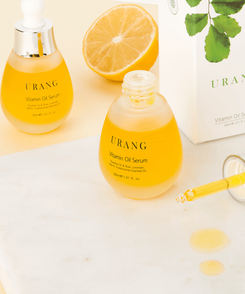 URANG Vitamin Oil Serum 30ml with dropper and box, showcasing vibrant serum and essential oils.