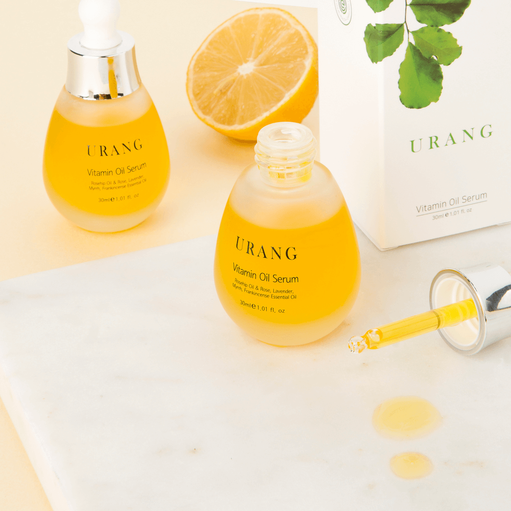 URANG Vitamin Oil Serum 30ml with dropper and box, showcasing vibrant serum and essential oils.