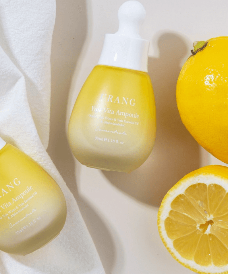 URANG Yuja Vita Ampoule with fresh yuja fruit on white background, highlighting its natural vitamin-rich formula for radiant skin.