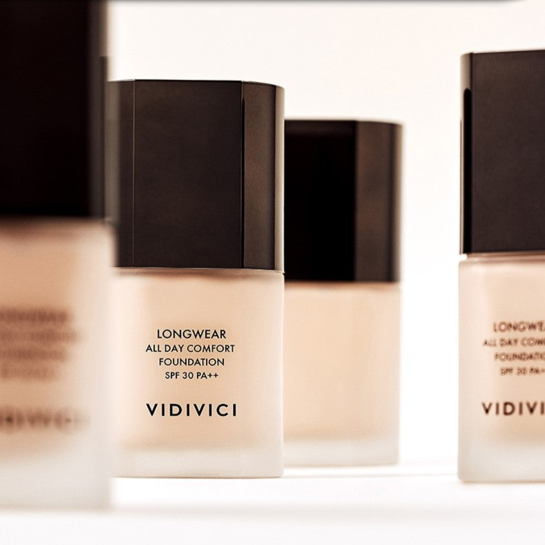 Bottle of VIDIVICI Longwear All Day Comfort Foundation SPF 30 PA++ in a product display setting.