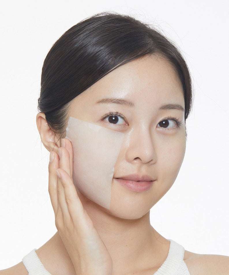 Woman applying VT COSMETIC Cryo Ice Skin Pack 210g on face for cooling and refreshing skincare experience.