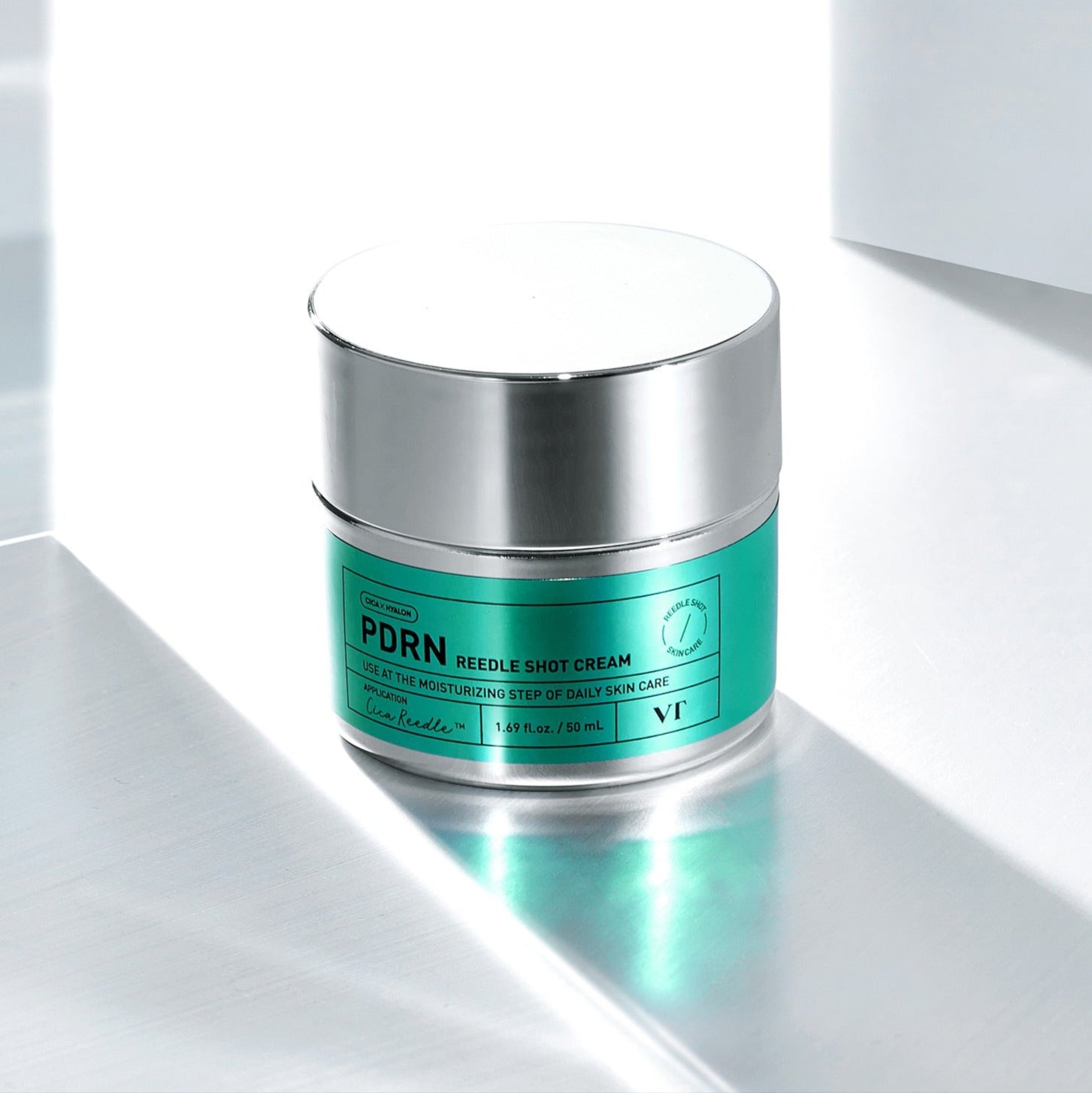 VT COSMETIC PDRN Riddle Shot Cream 50ml jar on reflective surface with vibrant green label for advanced skincare