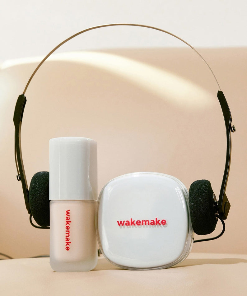 WAKE MAKE Seamless Wear Cushion 15g product display with wakemake branding on headphones and makeup packaging