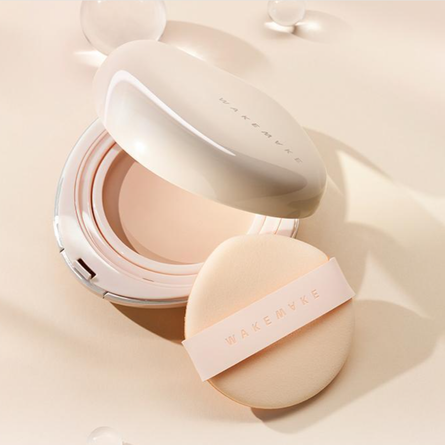 WAKE MAKE Water Glow Coating Balm 12.5g with applicator on beige background, showcasing makeup product design and packaging