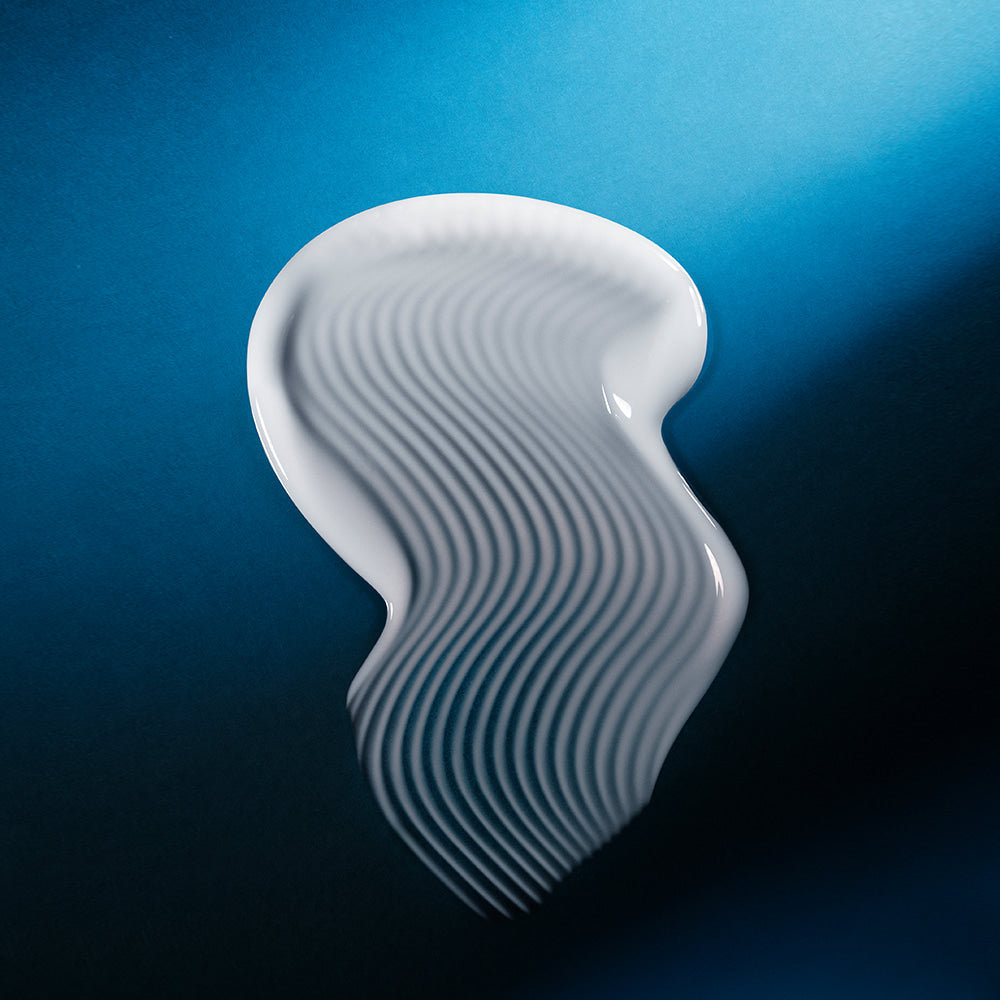 Texture of WELLAGE Hyper Peptide Bandage Cream 50ml on blue background
