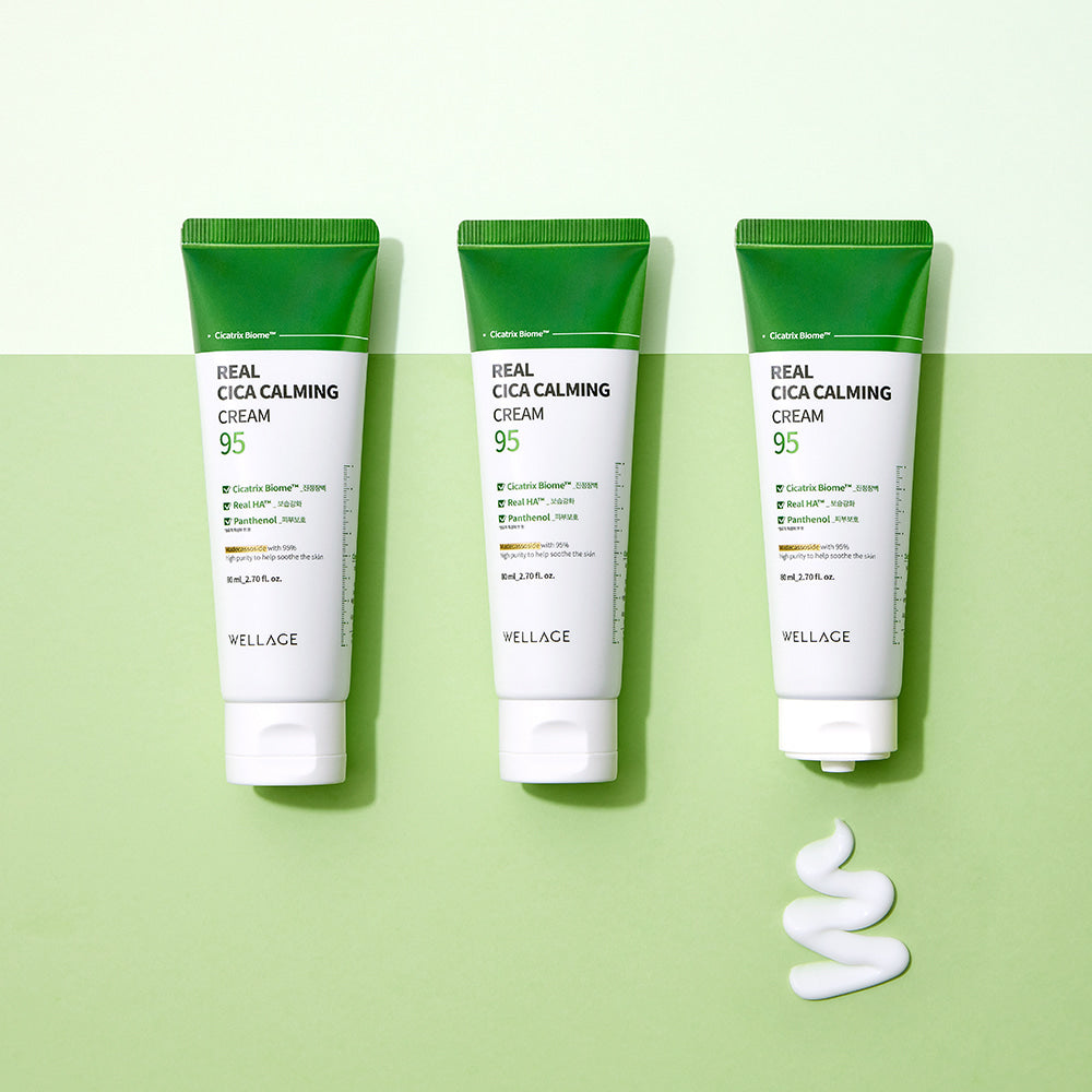 WELLAGE Real Cica Calming 95 Cream 80ml tubes on a green background with cream texture.