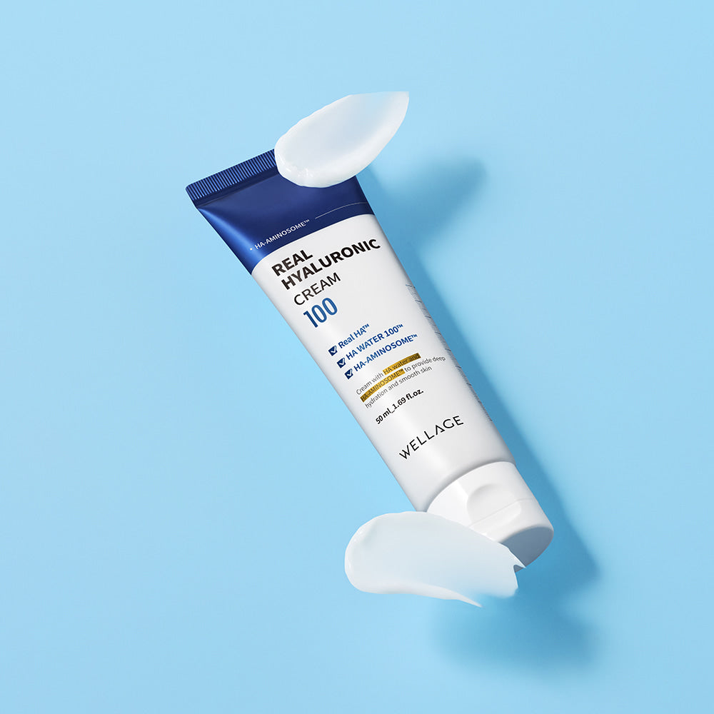 WELLAGE Real Hyaluronic 100 Cream 80ml tube on blue background with cream swirls.