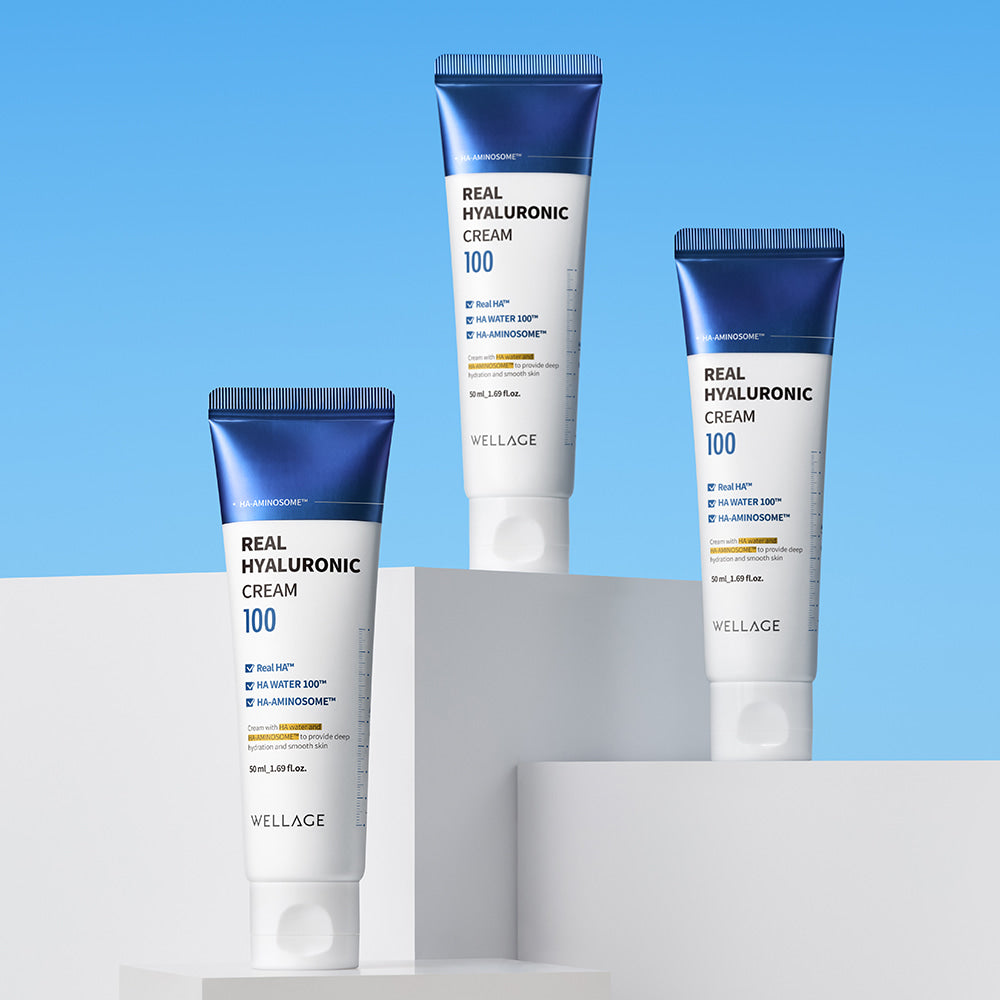 WELLAGE Real Hyaluronic 100 Cream 80ml tubes displayed on stands against blue background