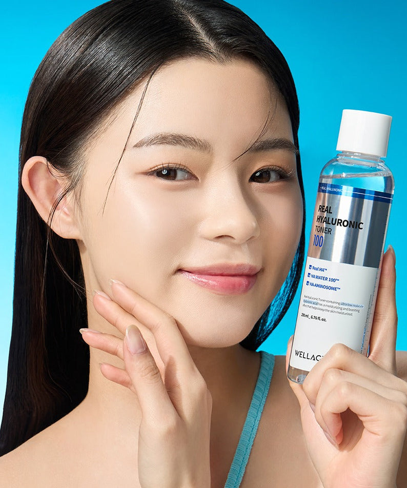 Woman holding WELLAGE Real Hyaluronic 100 Toner 200ml bottle with clear skin