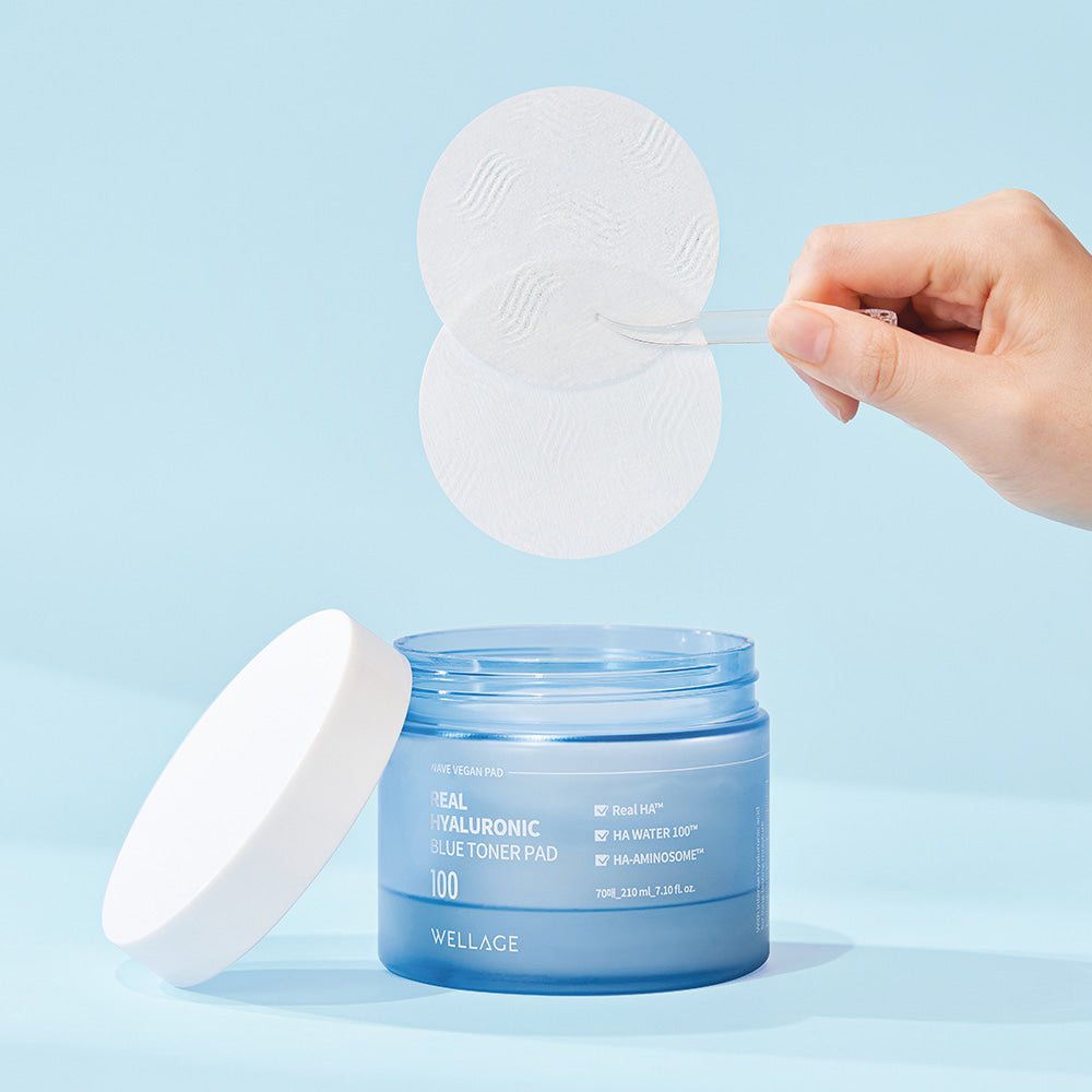 Container of WELLAGE Real hyaluronic Blue Toner Pads 70 Sheets with a hand lifting pads, ideal for skincare routine and hydration.