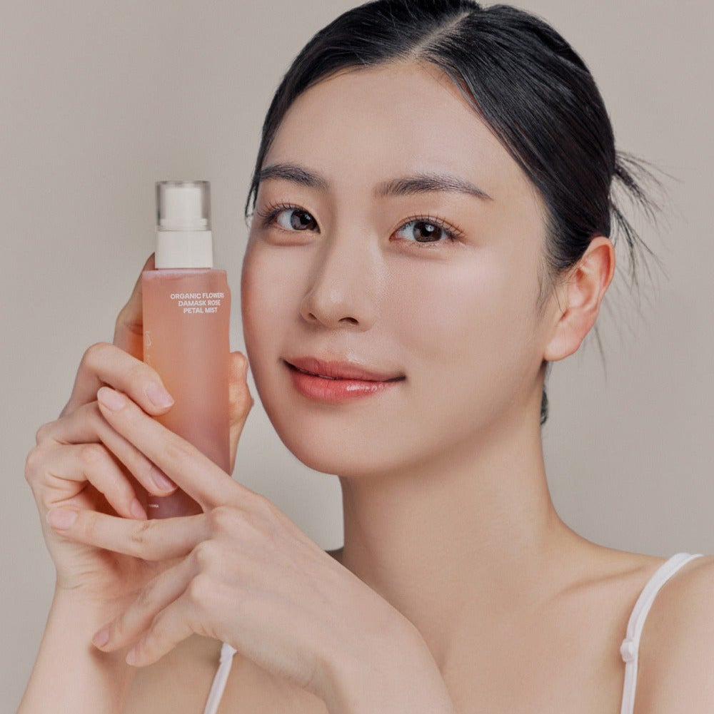 Person holding WHAMISA Organic Flower Fermented Rose Petal Mist 100ml.