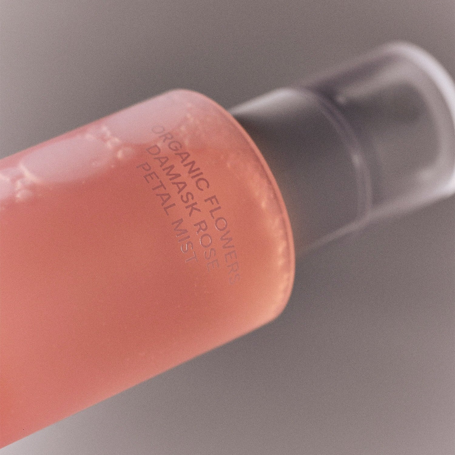 Bottle of WHAMISA Organic Flower Fermented Rose Petal Mist 100ml with pink liquid and pump dispenser