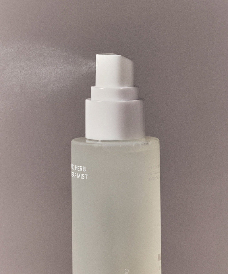 Spray bottle of WHAMISA Organic Herb Fermented Olive Leaf Mist 100ml releasing mist