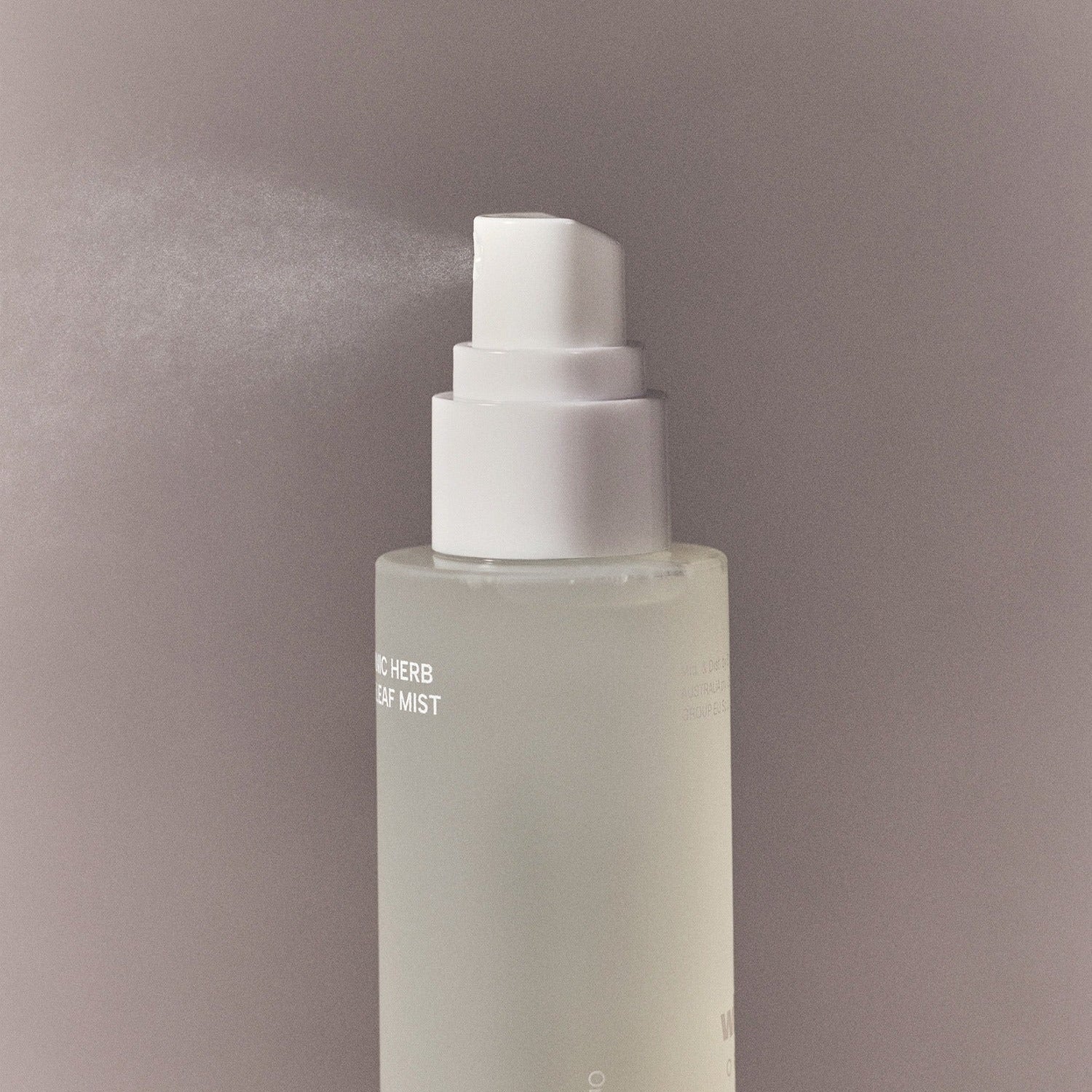 Spray bottle of WHAMISA Organic Herb Fermented Olive Leaf Mist 100ml releasing mist