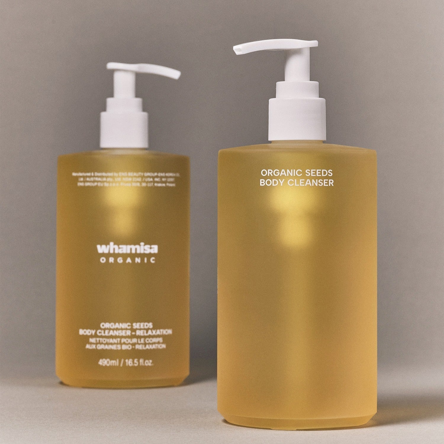 WHAMISA Organic Seed Fermented Body Cleanser 490ml in beige pump bottles on a gray background.