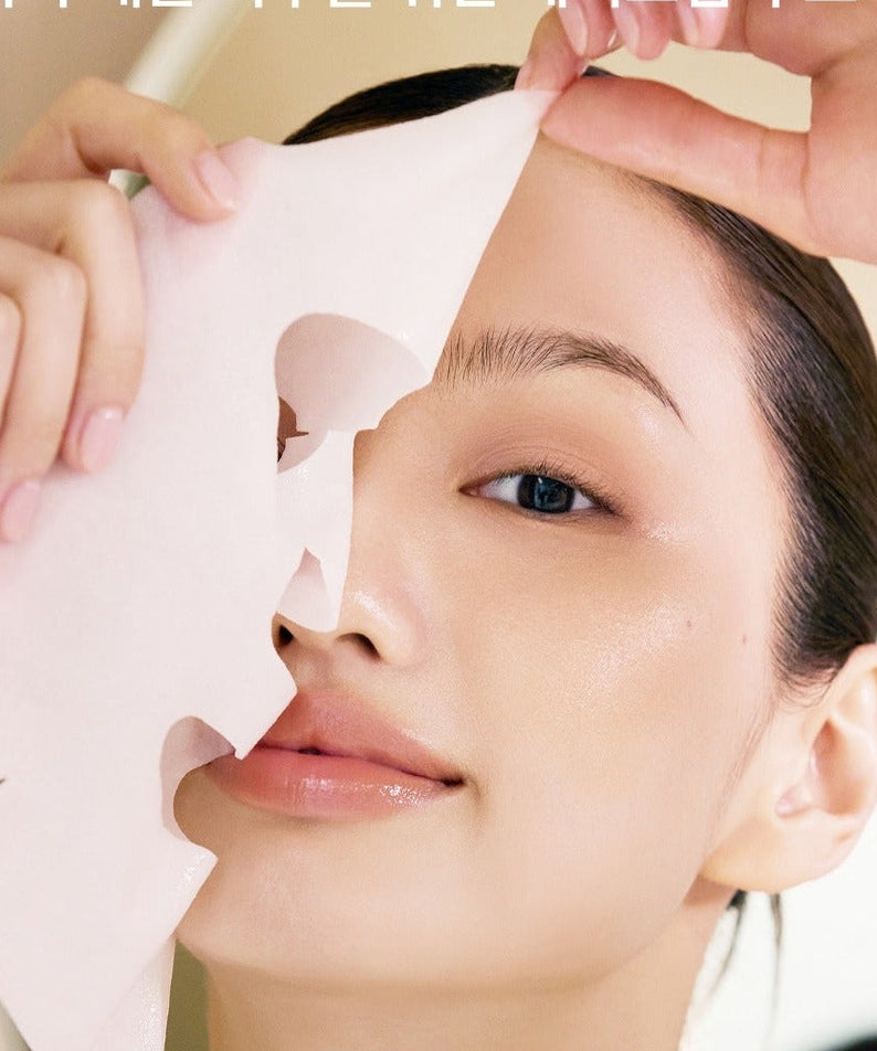 Model applying WHIPPED Butter Vegan Glow Barrier Squeeze Mask 1ea, showing skincare routine for radiant skin.