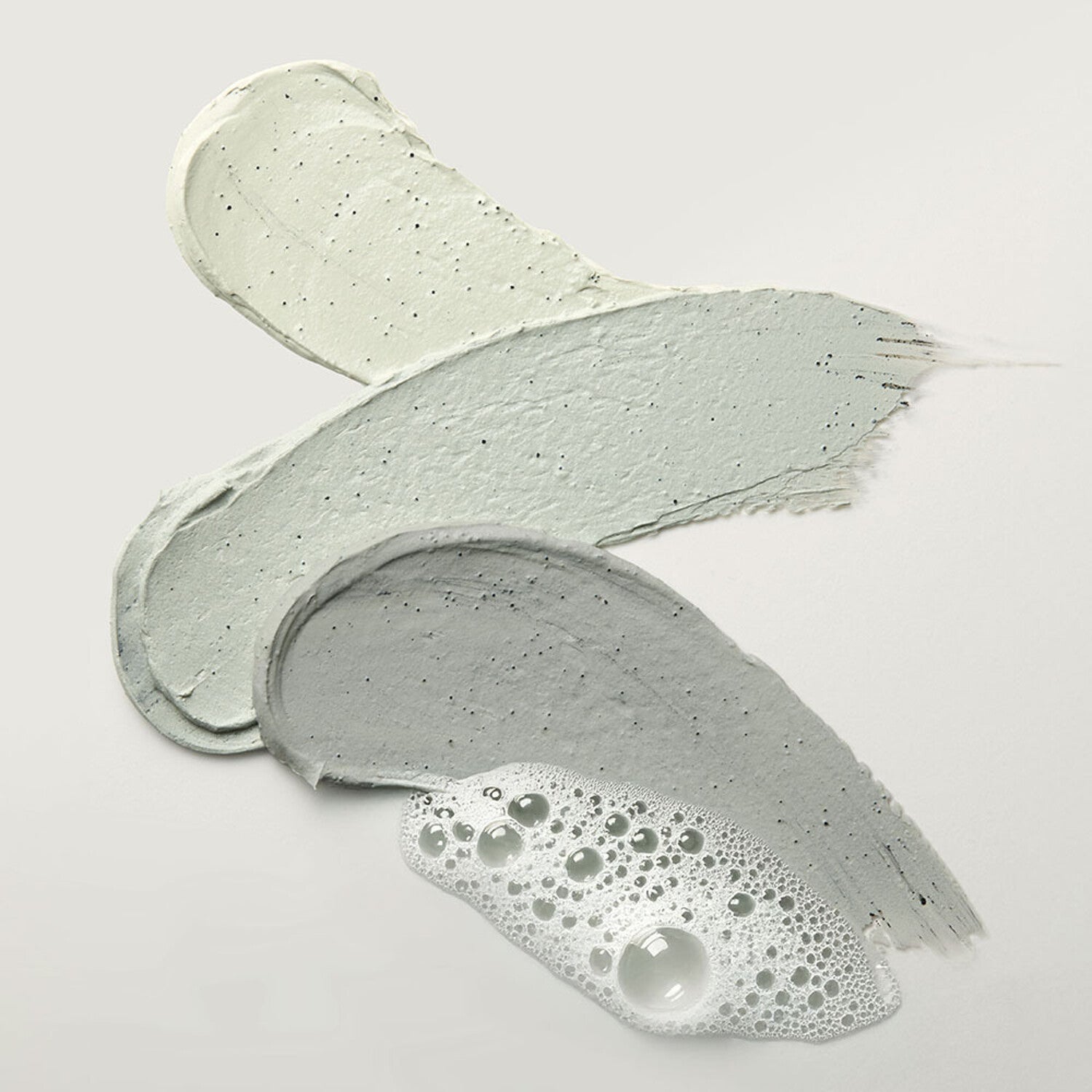 Texture swatches of WHIPPED Mugtree Vegan Cookie Clay Pack Cleanser 180ml, showcasing natural clay and foaming formula.