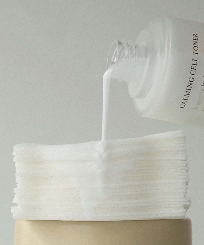 XOUL Calming Cell Toner 130ml being poured onto cotton pads for soothing skincare routine