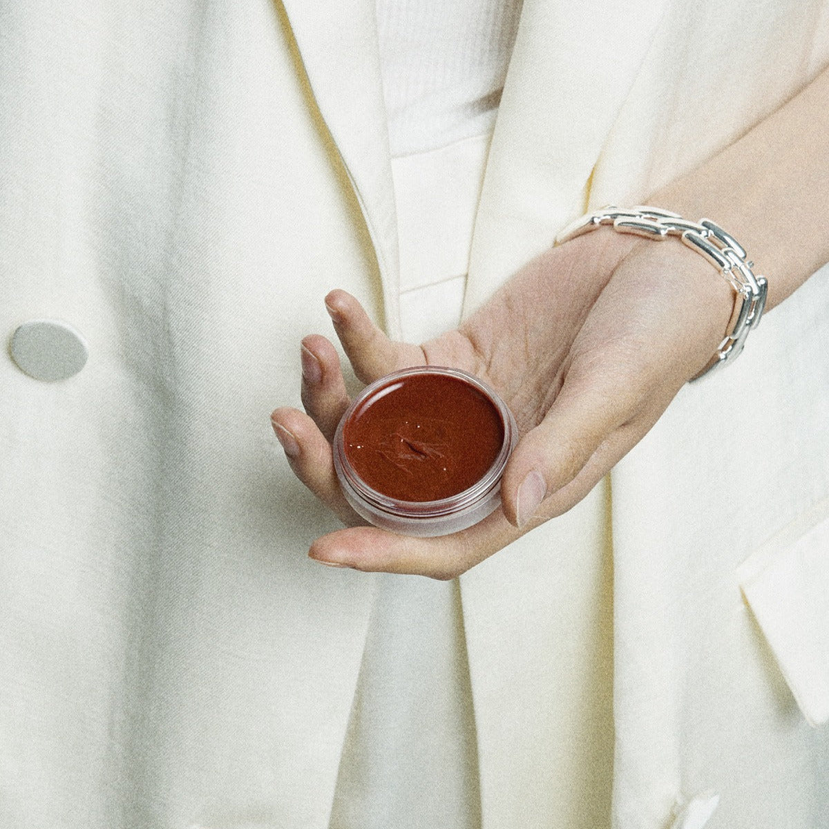 Person holding XOUL Ever Moist Volume Lip Balm 8g in hand, showcasing the smooth texture of the balm.