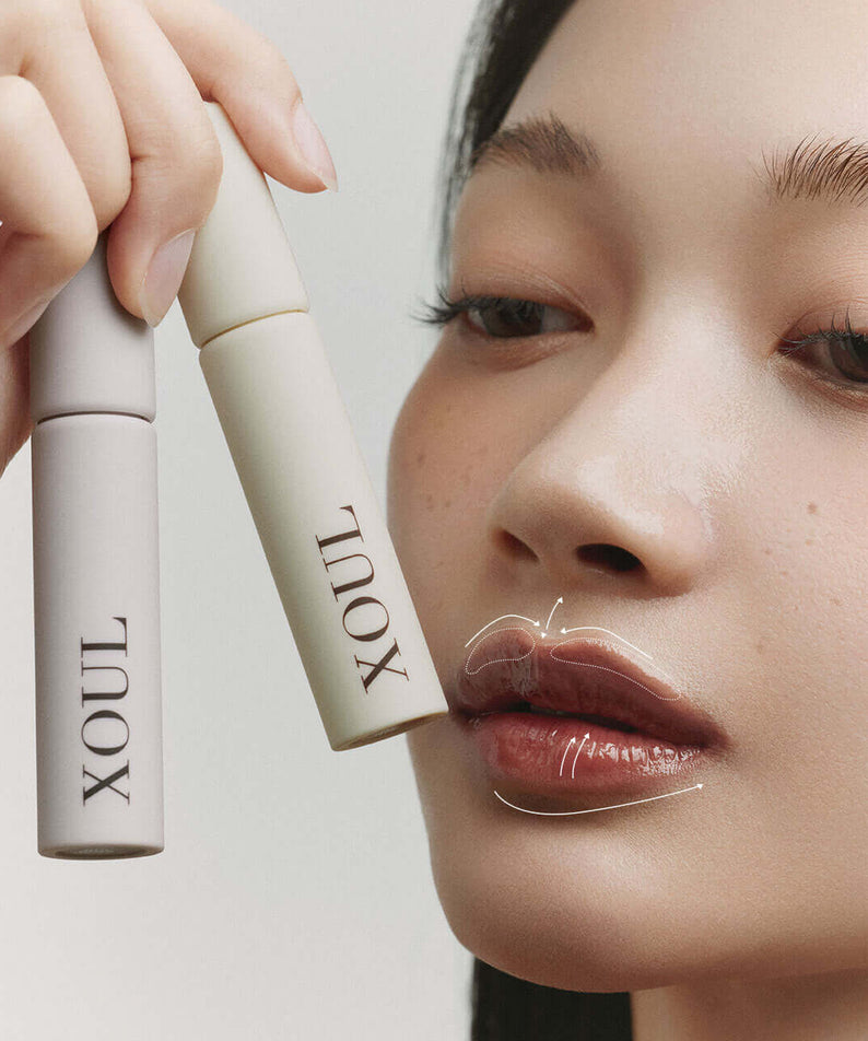 Woman applying XOUL Lip Line Tattoo for enhanced lip definition with XOUL products showcased.