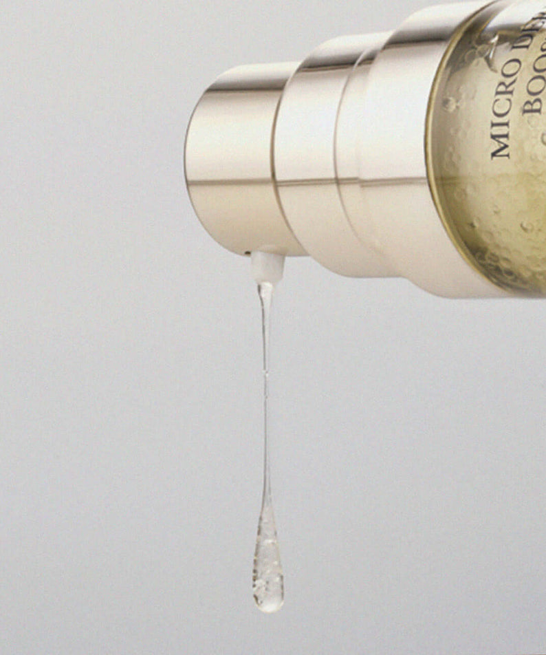 XOUL Micro Derma Booster 30ml serum drop detail showcasing product texture and luxurious packaging.