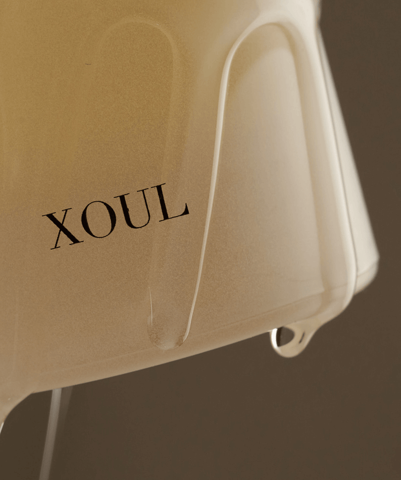 Close-up view of XOUL Pure Cell Cleansing Gel 130ml bottle with gel flowing, showcasing the product's texture and branding.