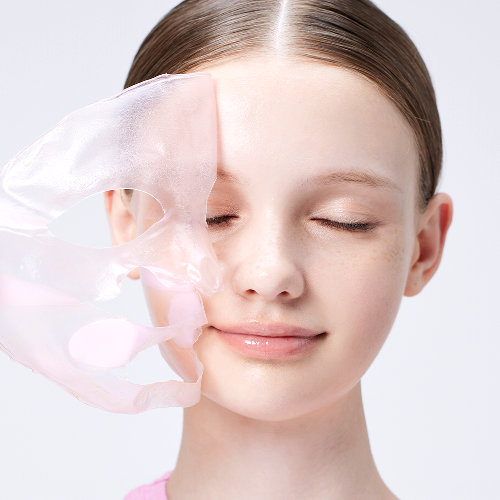 Woman applying COSRX The Peptide Collagen Lifting Glow Hydrogel Mask - 3 sheets