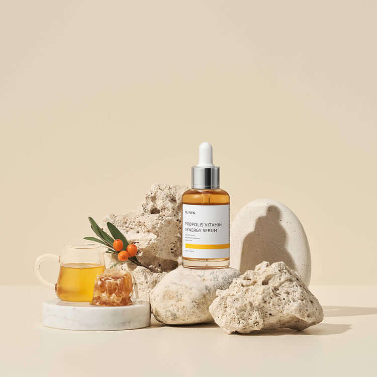 iUNIK Propolis Vitamin Synergy Serum 50ml bottle displayed with natural elements for skincare.